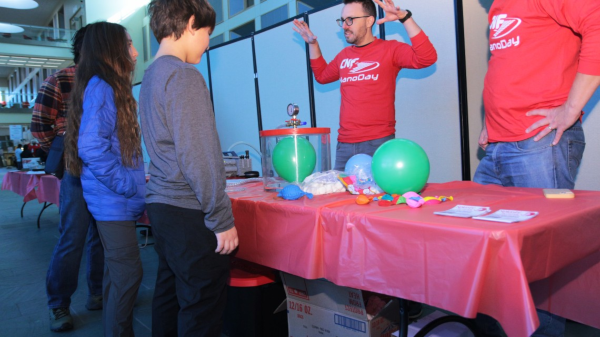 Jeremy Clark (CNF Plasma Etch and Deposition Specialist) teaches young people about vacuum technology at the CNF Nanoday celebration.  - Dave Botsch, Cornell University